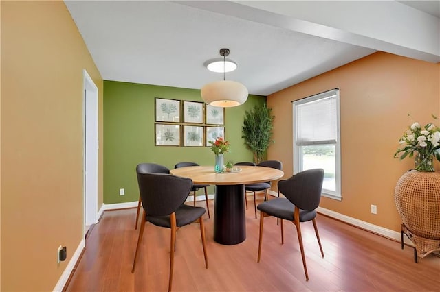 dining room featuring wood finished floors and baseboards