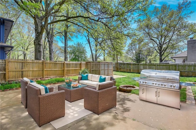 view of patio / terrace featuring an outdoor living space with a fire pit, a fenced backyard, and grilling area