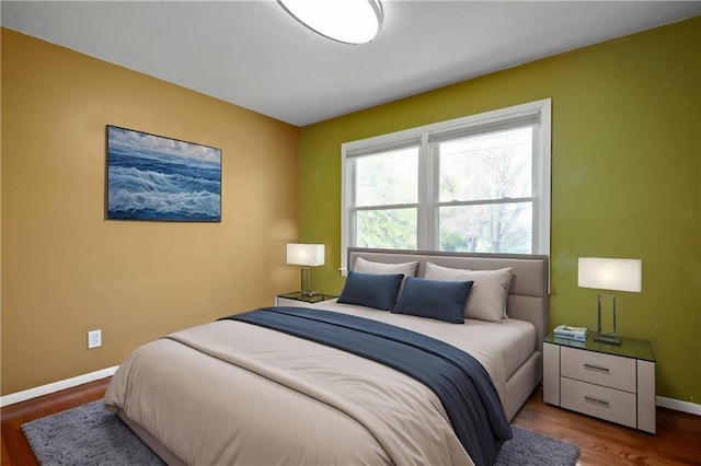 bedroom featuring baseboards and wood finished floors