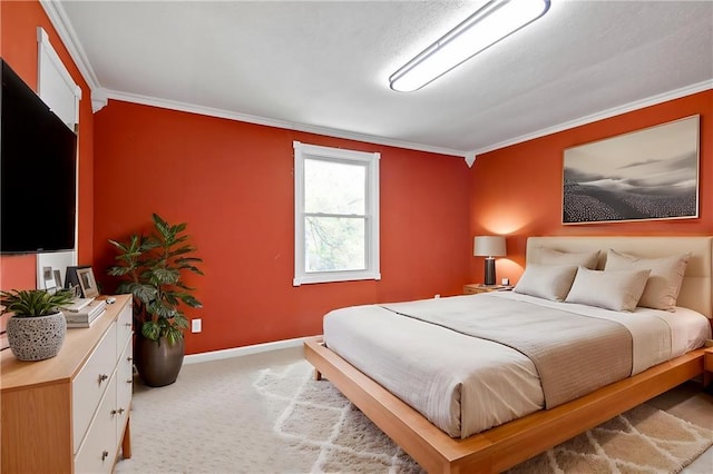 bedroom with baseboards, ornamental molding, and carpet flooring