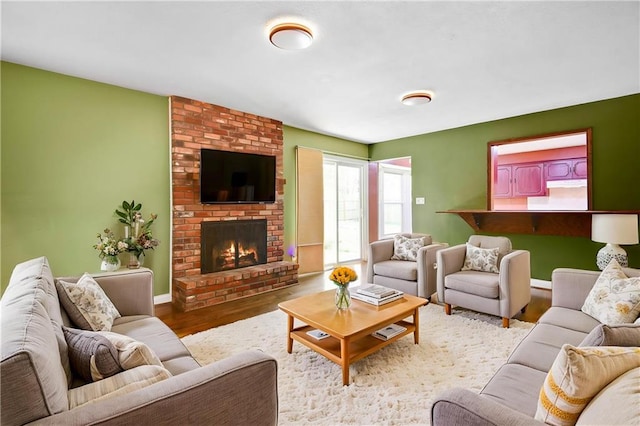 living area with wood finished floors and a fireplace