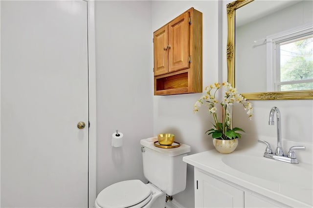 bathroom featuring toilet and vanity