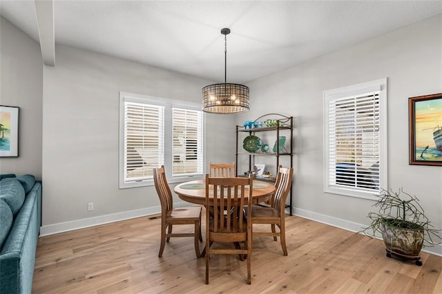 7209 Allman Dr, Shawnee, KS 66217 - dining area featuring a chandelier, light wood-style floors, healthy amount of natural light, and baseboards