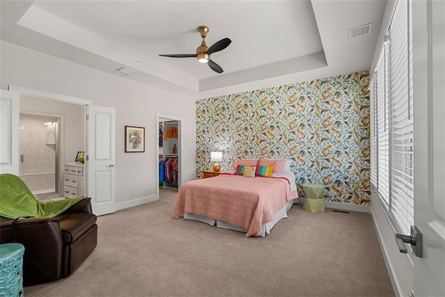 7209 Allman Dr, Shawnee, KS 66217 - bedroom with wallpapered walls, baseboards, multiple windows, a tray ceiling, and light carpet