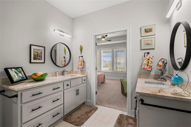 7209 Allman Dr, Shawnee, KS 66217 - ensuite bathroom featuring two vanities, ceiling fan, baseboards, and tile patterned floors