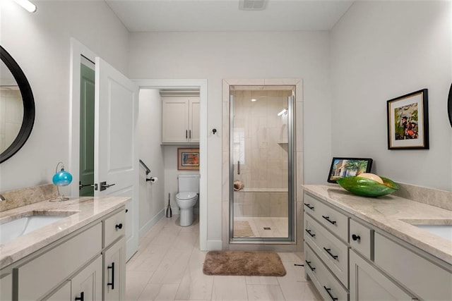 7209 Allman Dr, Shawnee, KS 66217 - full bath with two vanities, a shower stall, toilet, and marble look tile flooring