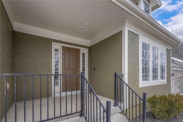 entrance to property featuring stucco siding