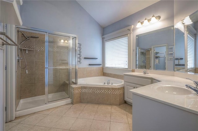 bathroom with a stall shower, tile patterned floors, a sink, vaulted ceiling, and a bath