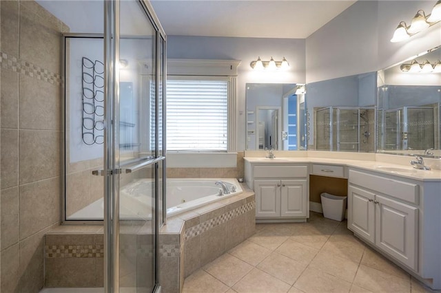 full bath with a garden tub, a shower stall, vanity, and tile patterned floors