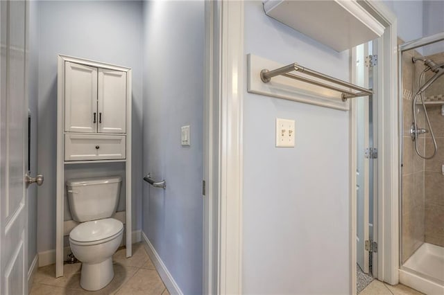 full bathroom featuring baseboards, a shower stall, toilet, and tile patterned floors