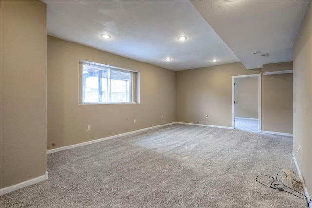 spare room with baseboards, carpet flooring, and recessed lighting