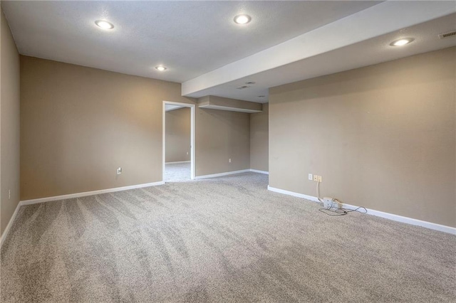 carpeted spare room featuring baseboards and recessed lighting