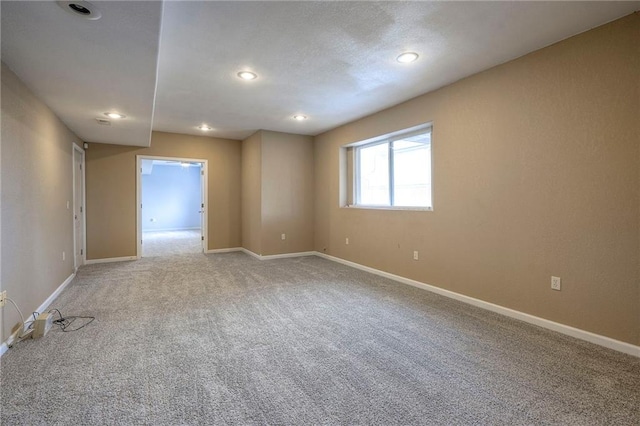 unfurnished room featuring carpet floors, baseboards, and recessed lighting