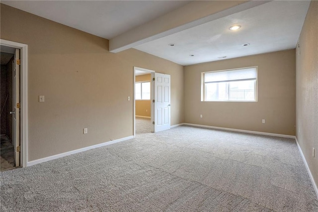 spare room with recessed lighting, baseboards, beamed ceiling, and light colored carpet