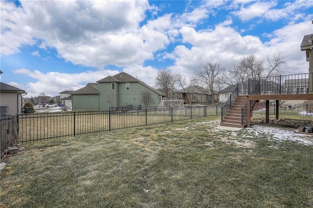 view of yard with stairs, a wooden deck, fence, and a residential view