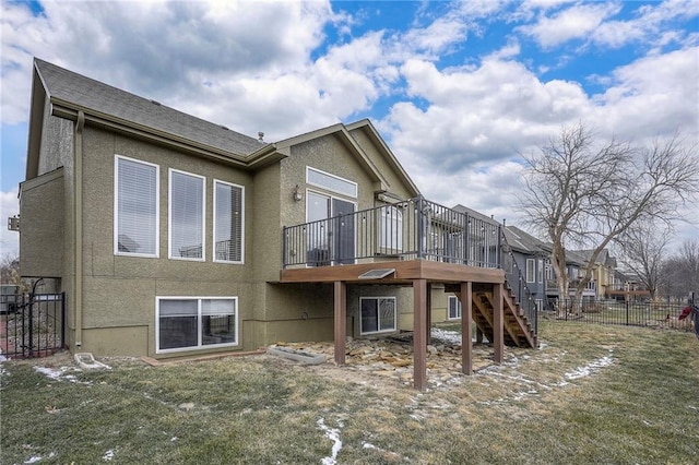 rear view of house featuring stairs, fence, a wooden deck, and stucco siding