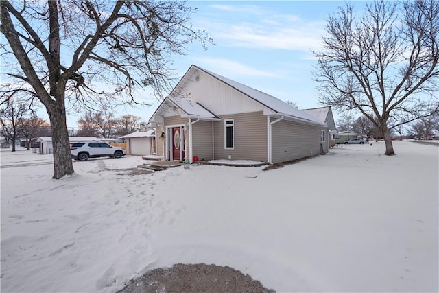 view of snowy exterior with a garage