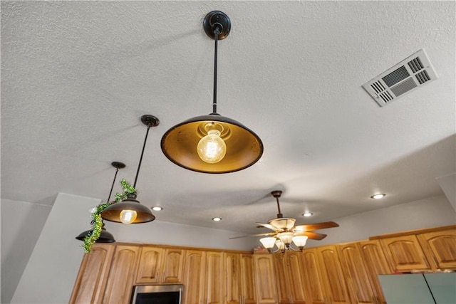 interior details featuring pendant lighting and ceiling fan