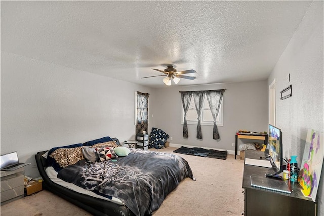 carpeted bedroom with ceiling fan and a textured ceiling