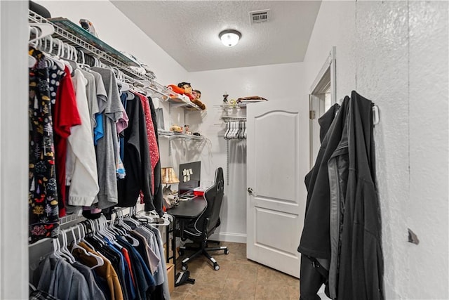 walk in closet featuring light tile patterned floors