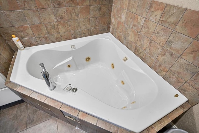 bathroom with a relaxing tiled tub