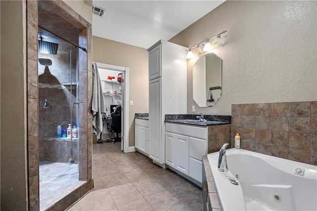 bathroom with tile patterned floors, vanity, and separate shower and tub