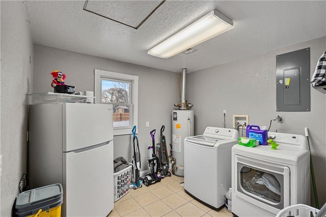 clothes washing area with gas water heater, light tile patterned floors, electric panel, washing machine and dryer, and a textured ceiling