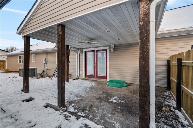 snow covered patio featuring central AC and ceiling fan