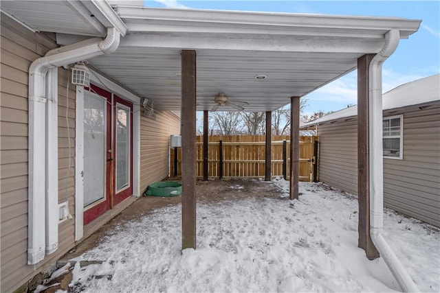 snow covered patio featuring ceiling fan