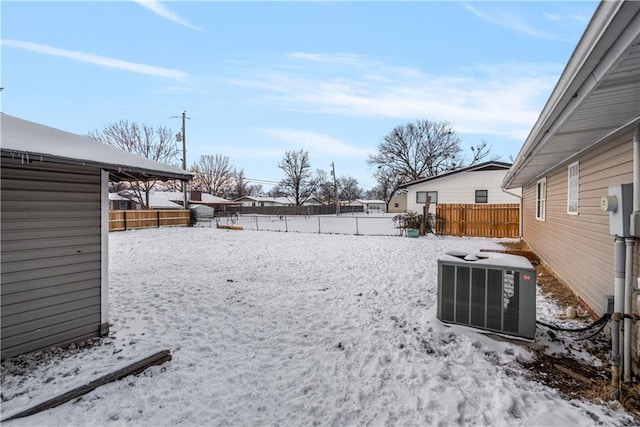 yard layered in snow with central air condition unit