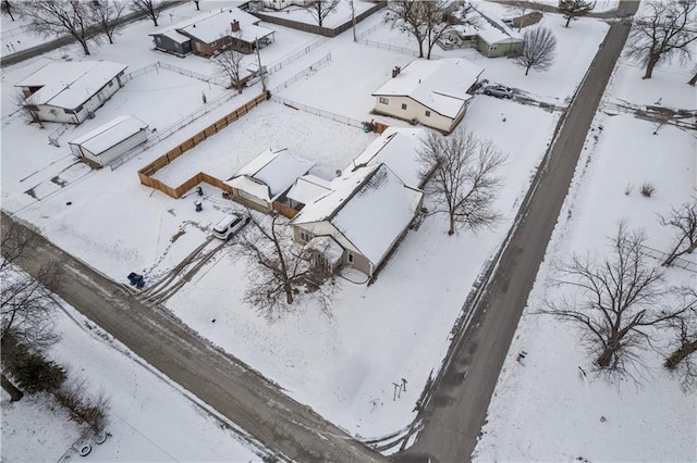 snowy aerial view featuring a residential view