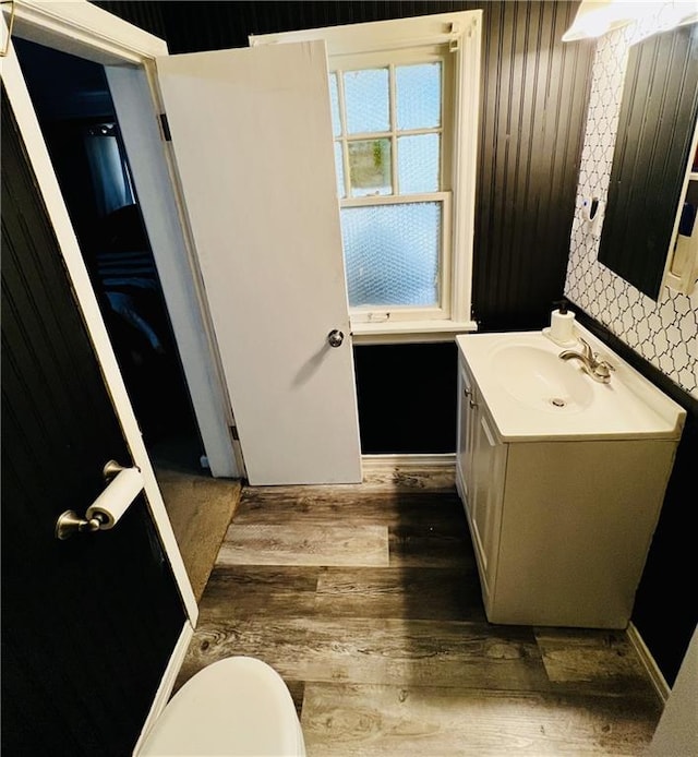 bathroom featuring vanity, hardwood / wood-style floors, and toilet