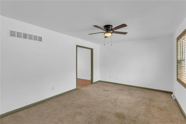 unfurnished room with ceiling fan and light colored carpet