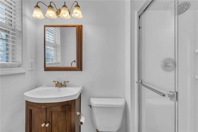 bathroom featuring walk in shower, vanity, and toilet