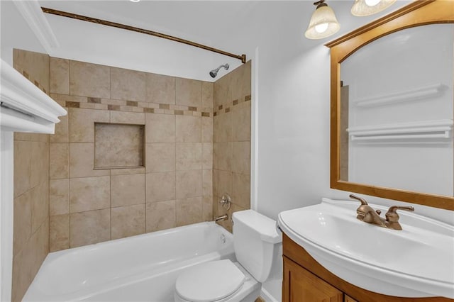 full bathroom featuring vanity, toilet, and tiled shower / bath combo