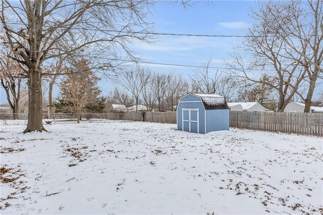 yard covered in snow with a storage shed