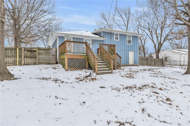 snow covered property featuring a deck