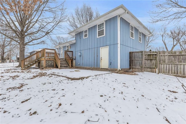 snow covered property featuring a wooden deck