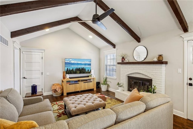 living room with dark hardwood / wood-style floors, ceiling fan, vaulted ceiling with beams, and a fireplace