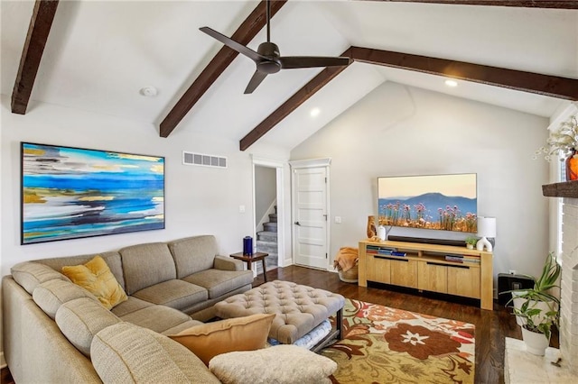 living room featuring ceiling fan, dark hardwood / wood-style floors, a fireplace, and vaulted ceiling with beams