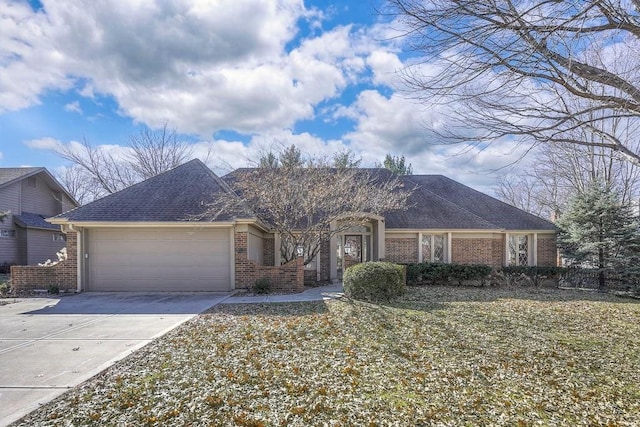 single story home with a garage, concrete driveway, brick siding, and roof with shingles