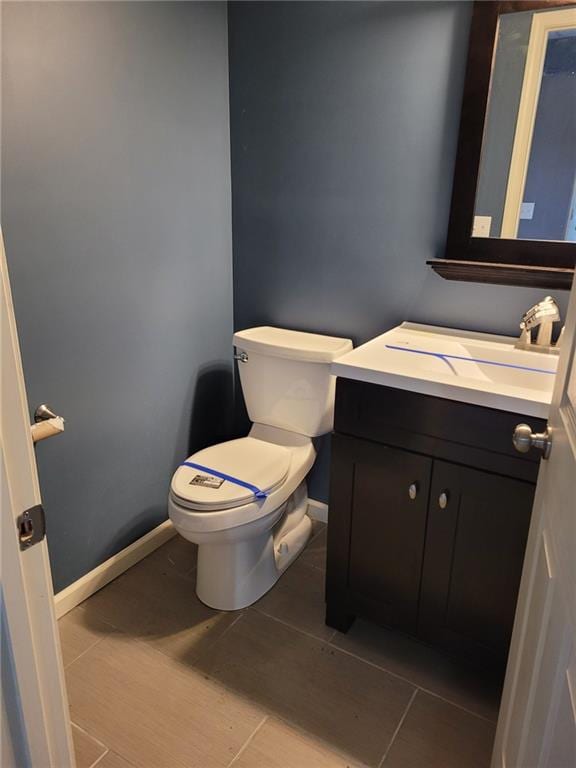 bathroom with tile patterned floors, vanity, and toilet