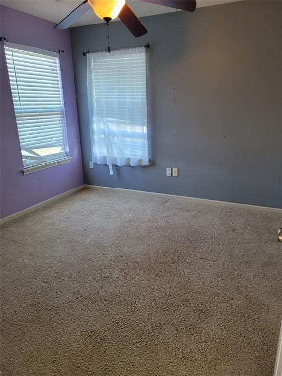 unfurnished room with ceiling fan and carpet flooring