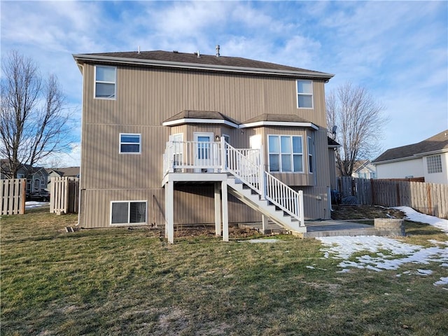 rear view of house with a lawn and a deck