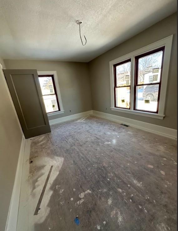 empty room with a textured ceiling