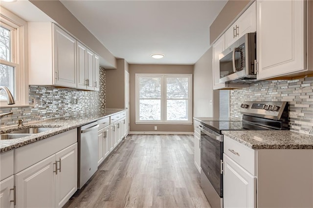 kitchen featuring white cabinetry, appliances with stainless steel finishes, and sink