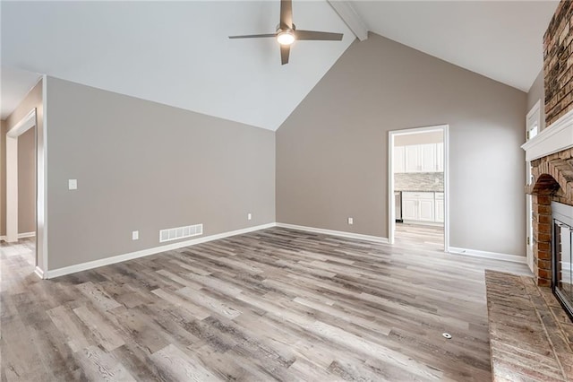 bonus room featuring ceiling fan, a fireplace, beam ceiling, and light hardwood / wood-style flooring