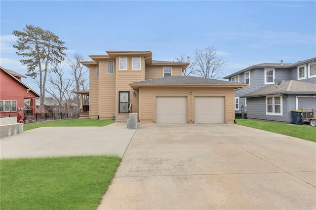 view of front of house with a garage and a front lawn