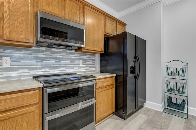 5312 Woodland Ave, Kansas City, MO 64110 - kitchen with backsplash, stainless steel appliances, crown molding, light stone countertops, and light hardwood / wood-style flooring