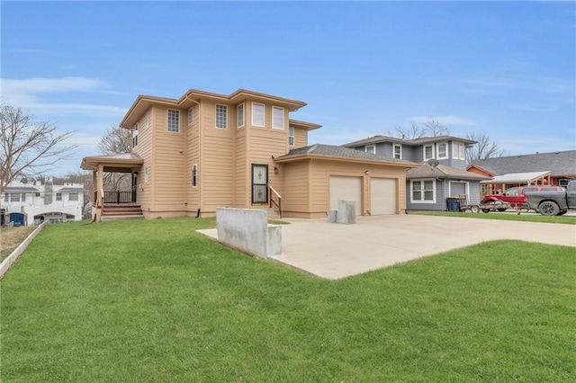5312 Woodland Ave, Kansas City, MO 64110 - back of house with a garage and a lawn